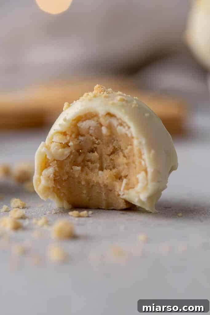 Golden Oreo Cheesecake Truffles 2 Close up of the Golden Oreo truffles, showcasing their white chocolate coating and golden crumbs.