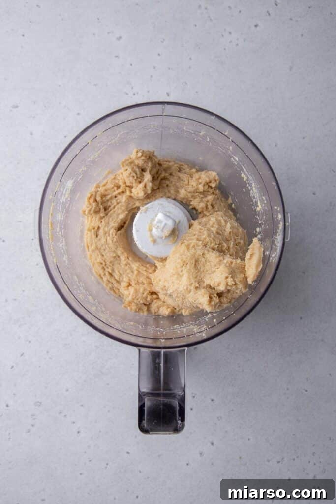 Golden Oreo Cheesecake Truffles 5 Oreo and cream cheese mixture blending in a food processor.