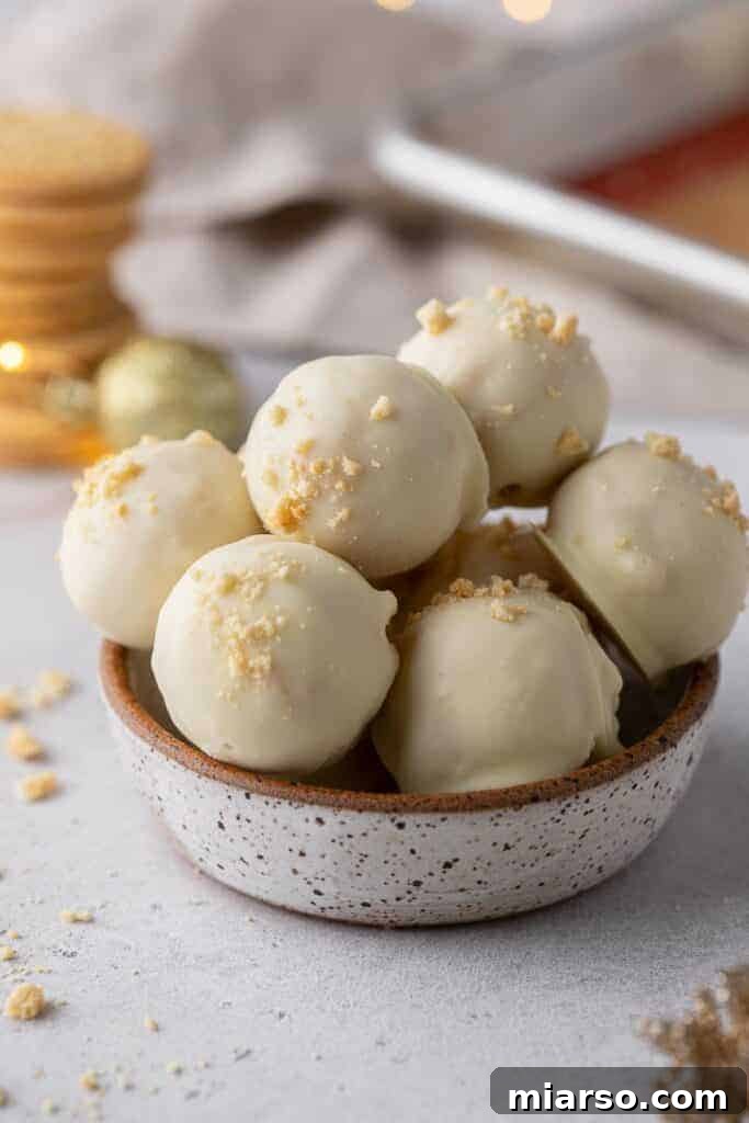 Golden Oreo Cheesecake Truffles 10 A plate of perfectly formed Golden Oreo truffles, garnished with sprinkles.