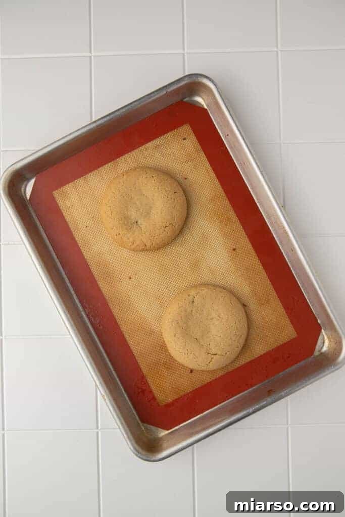 Crumbl Sticky Bun Cookie Perfection 8 Baked thick cookies on baking sheet