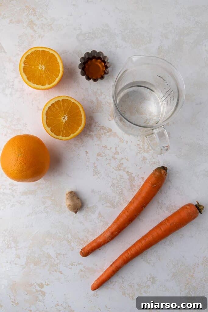 Golden Immunity Zest Smoothie 3 Fresh oranges, peeled carrots, and a piece of ginger root laid out on a cutting board, ready for a smoothie.
