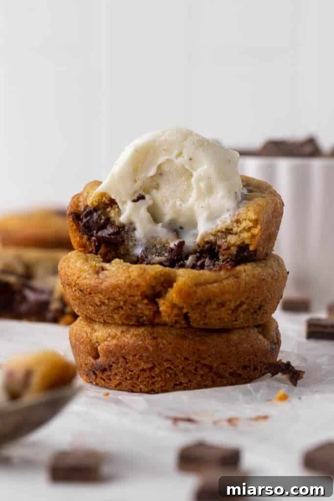 Warm cookie cups topped with a scoop of ice cream