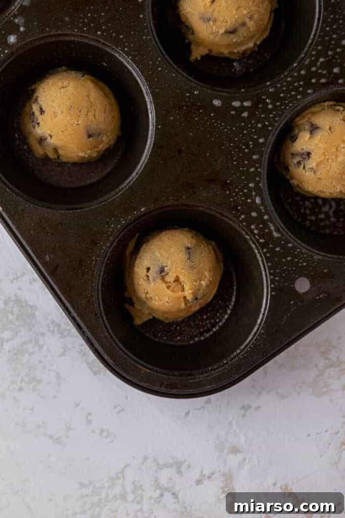 Cookie cups baking in a muffin tin