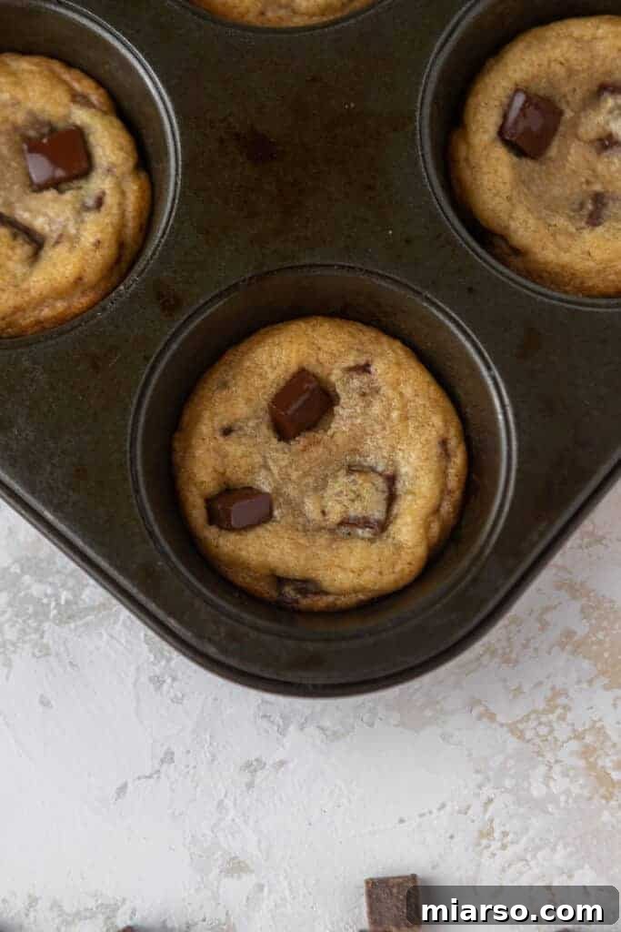 Warm, freshly baked cookie cups in the tin