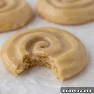 Crumbl honey bun cookie with a bite taken out of it