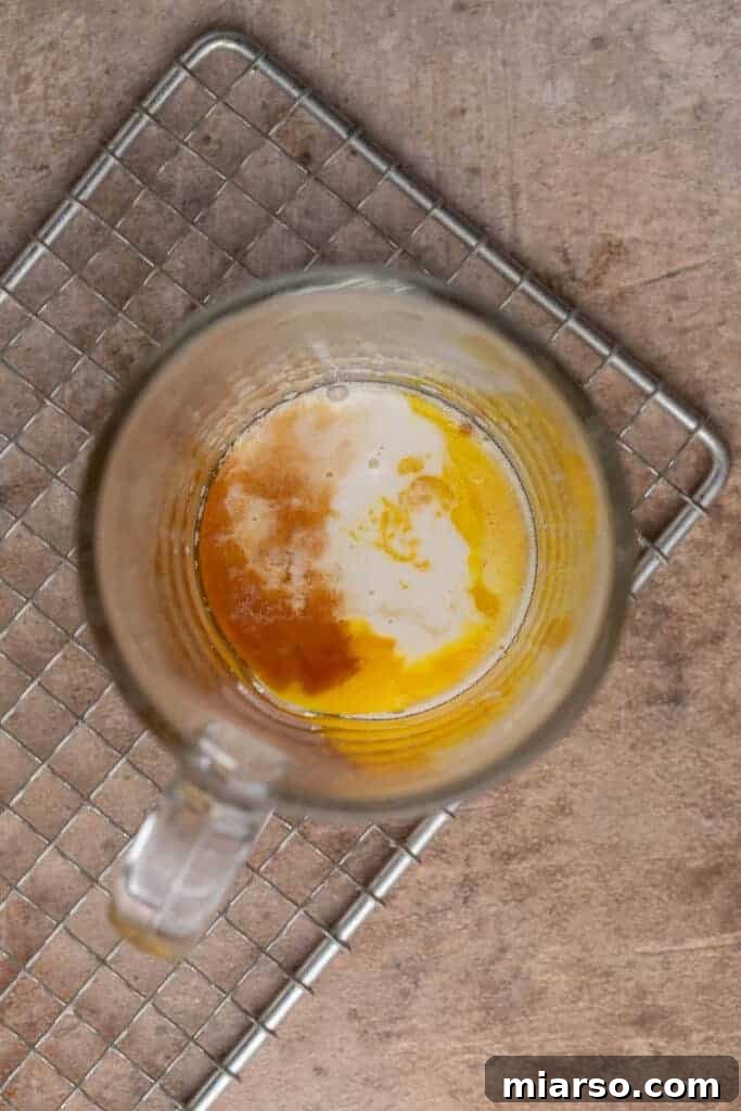 Wet ingredients in a mug, ready to be mixed for a protein mug cake.