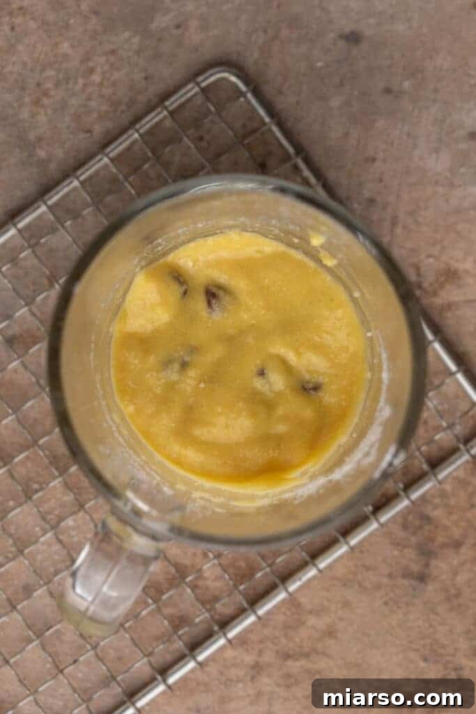 Protein cake batter in a mug, showing consistency before microwaving.