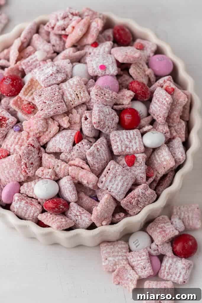 Cupid's Crunch 17 A ceramic bowl filled with colorful Valentine's Day puppy chow, ready to be served.