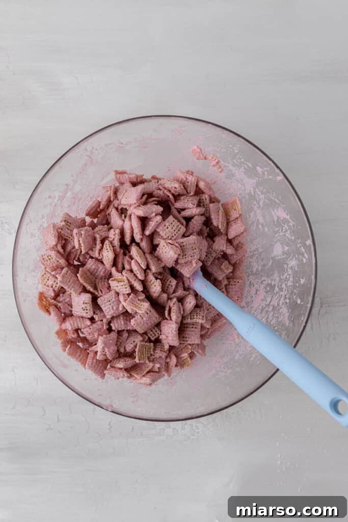 Cupid's Crunch 6 Close-up of pink candy melt coated Chex cereal, showing even coverage.