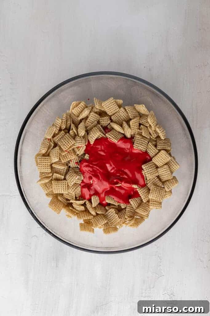Cupid's Crunch 10 Chex cereal with melted red candy melts poured over, before mixing.