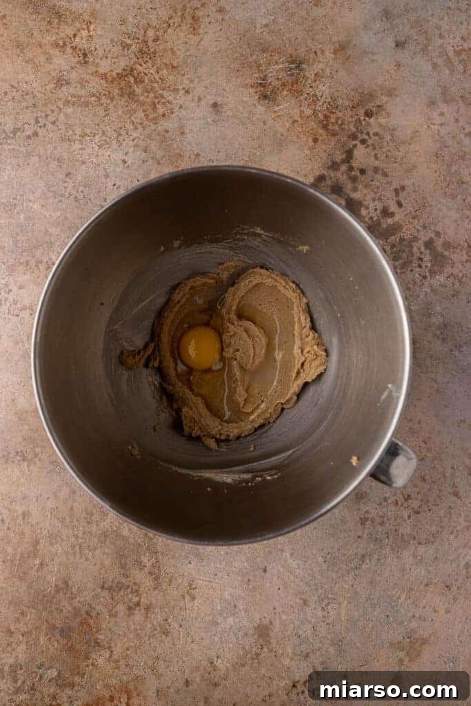 Creamed butter and egg in a mixing bowl for cookie dough