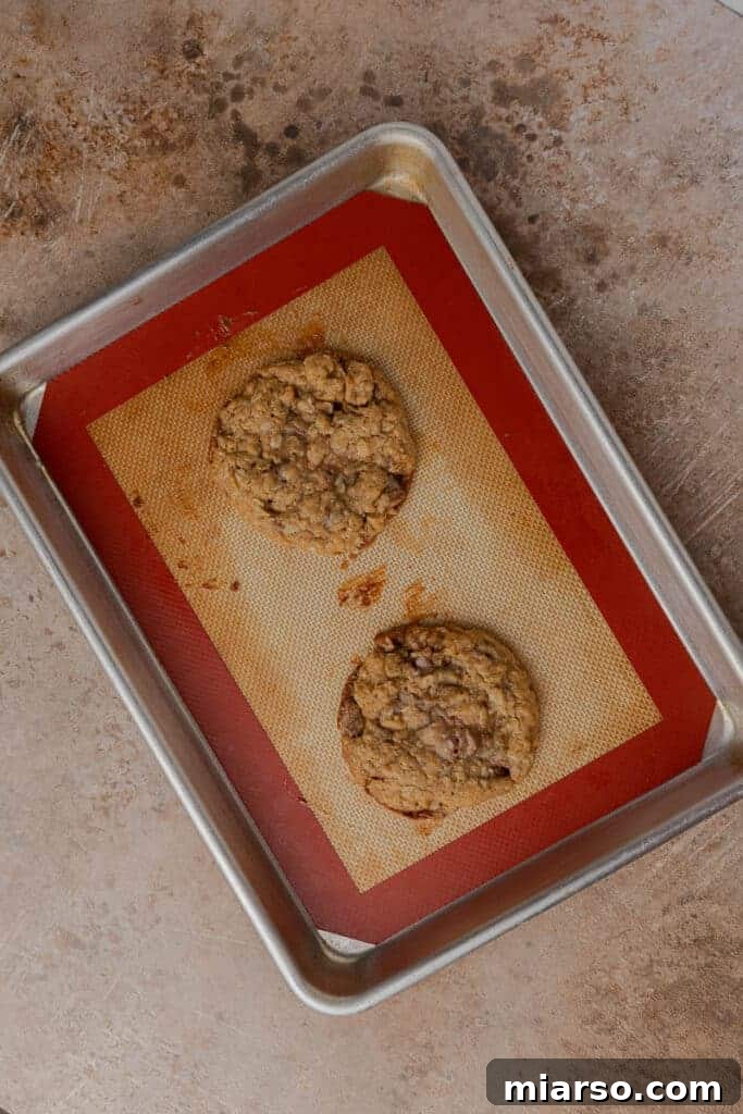 Freshly baked oatmeal caramel cookies on a baking sheet