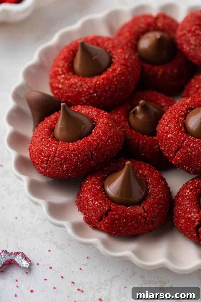 Hershey's Kissed Red Velvet Cookies 2 Hershey's red velvet blossoms on a plate, beautifully arranged for a festive occasion