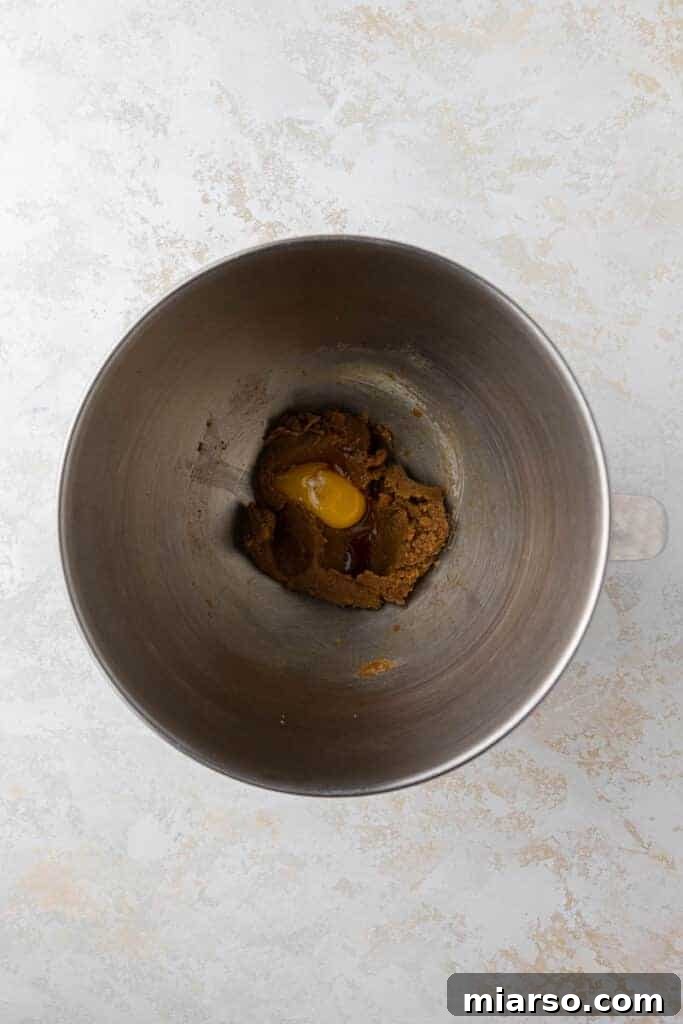 Hershey's Kissed Red Velvet Cookies 5 Creamed butter and sugar in mixing bowl, forming the base of the red velvet cookie dough