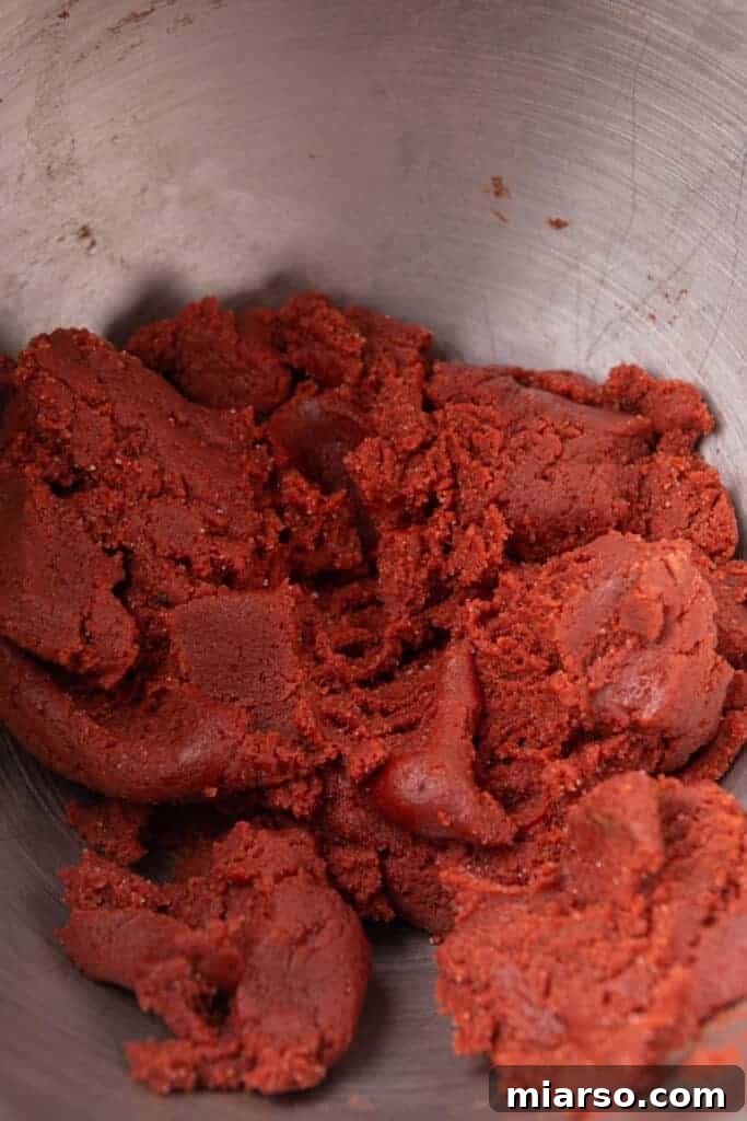 Hershey's Kissed Red Velvet Cookies 6 Vibrant red velvet cookie dough in mixing bowl, ready for shaping