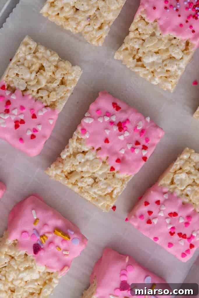 Valentine's day Rice Krispie treats being dipped