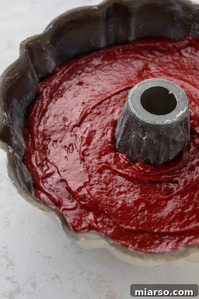Red cake batter in a bundt pan