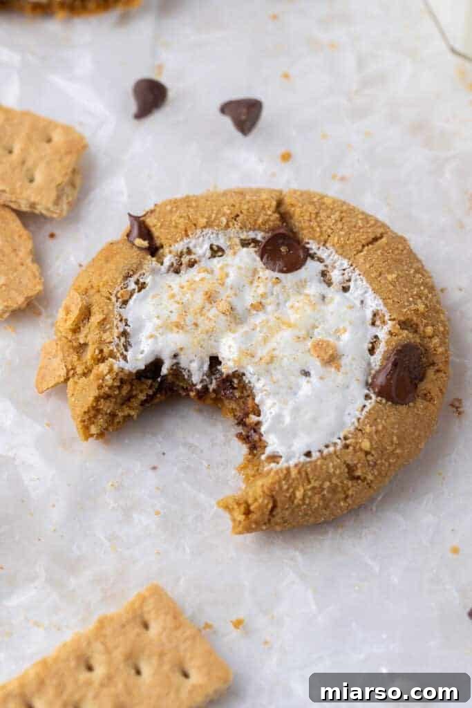 Crumbl S'mores cookie with a bite taken out, showing gooey marshmallow