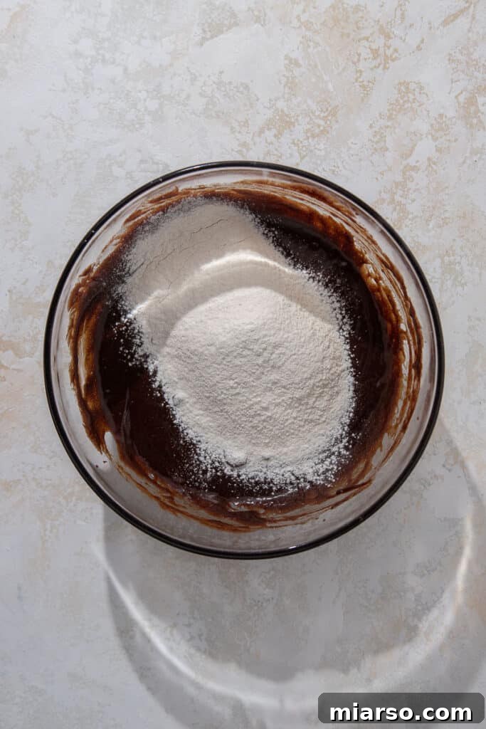 Melted chocolate mixture in a bowl with flour