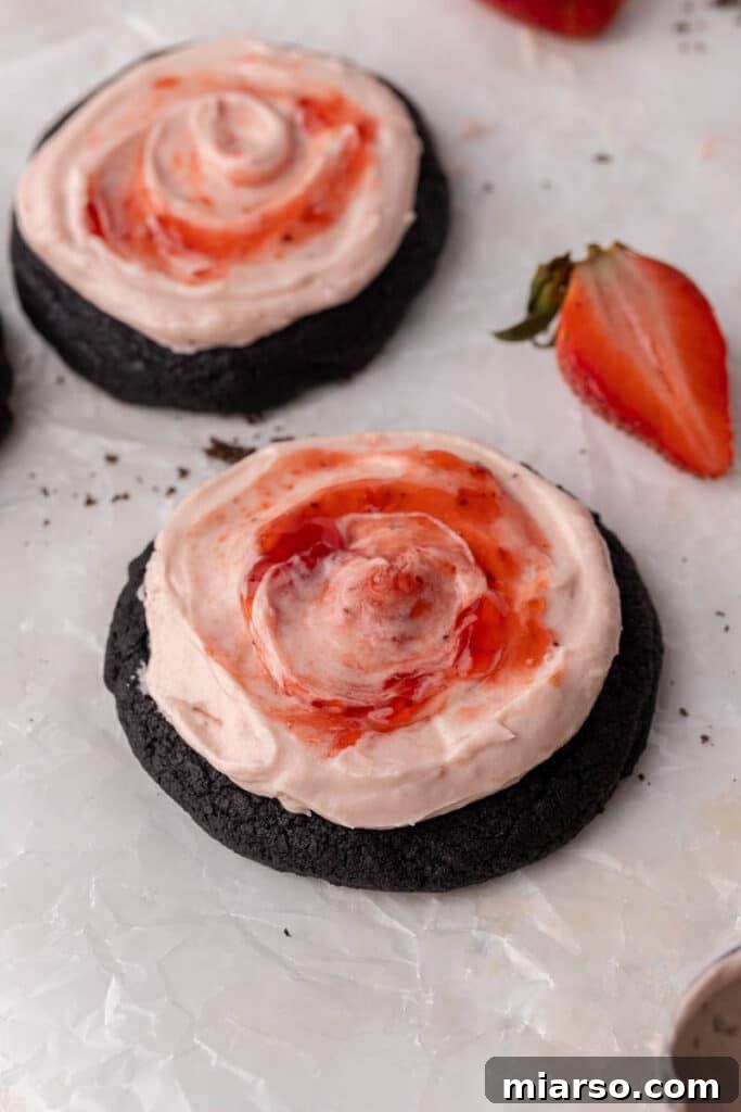 A delectable stack of Crumbl chocolate strawberry cheesecake cookies, beautifully frosted and garnished for serving.