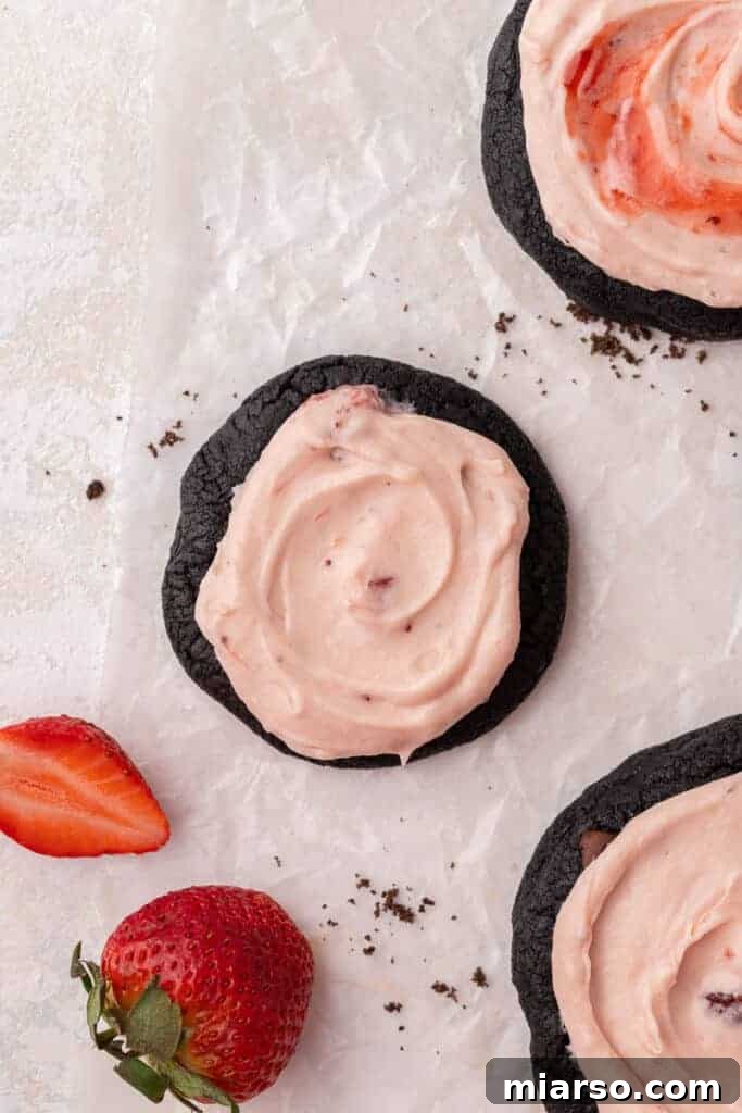A full tray of smaller, catering-sized Crumbl chocolate strawberry cheesecake cookies, perfect for events.