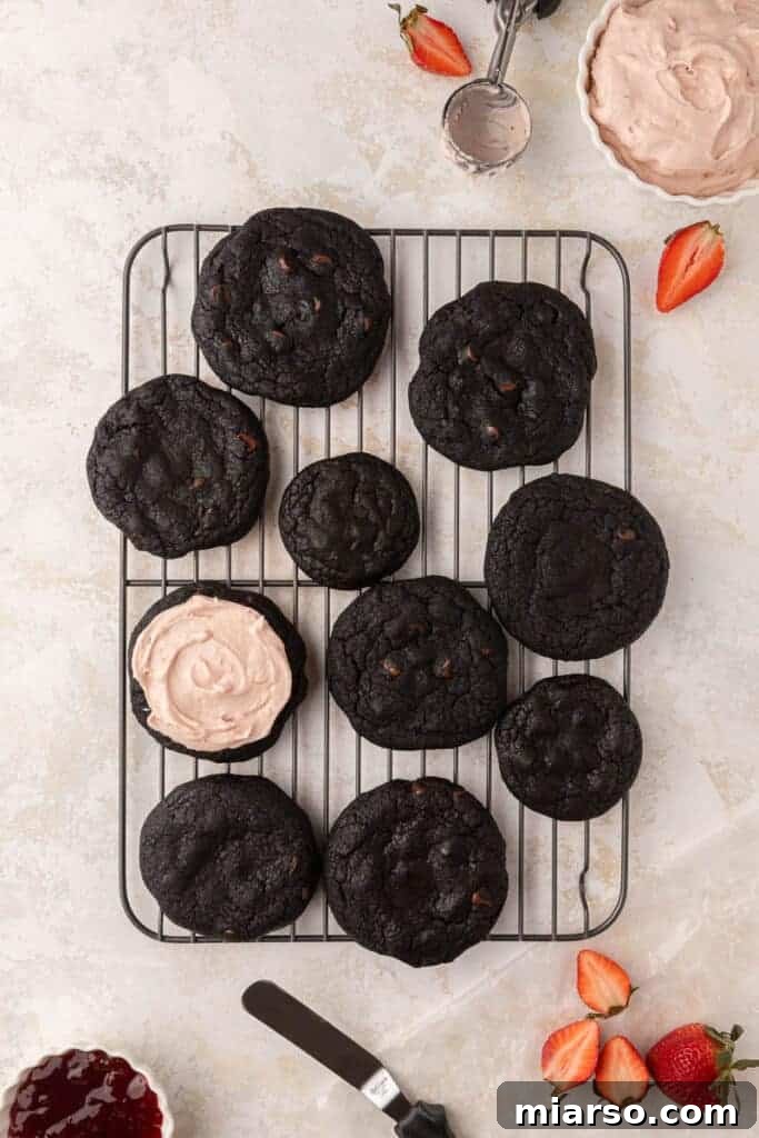 Beautifully frosted black cocoa cookies with strawberry cream cheese topping, ready to be enjoyed.