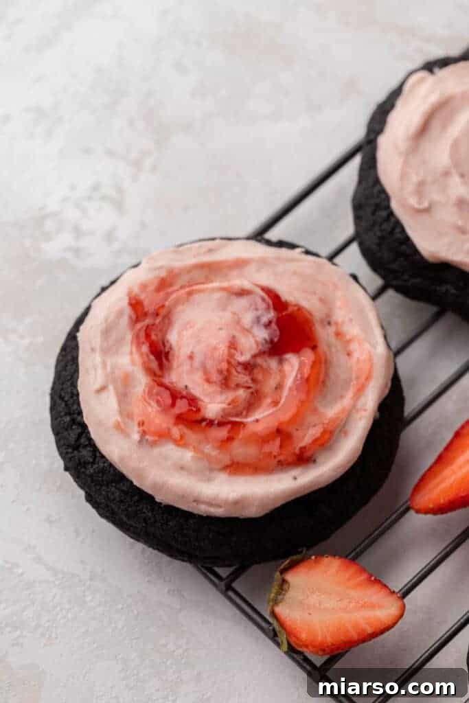 Step 6: Close-up of a chocolate strawberry cheesecake cookie with a delicate swirl of strawberry jam on top.