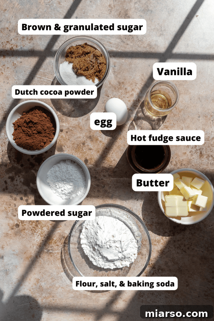 Ingredients for Crumbl Molten Lava Cookies laid out on a baking sheet