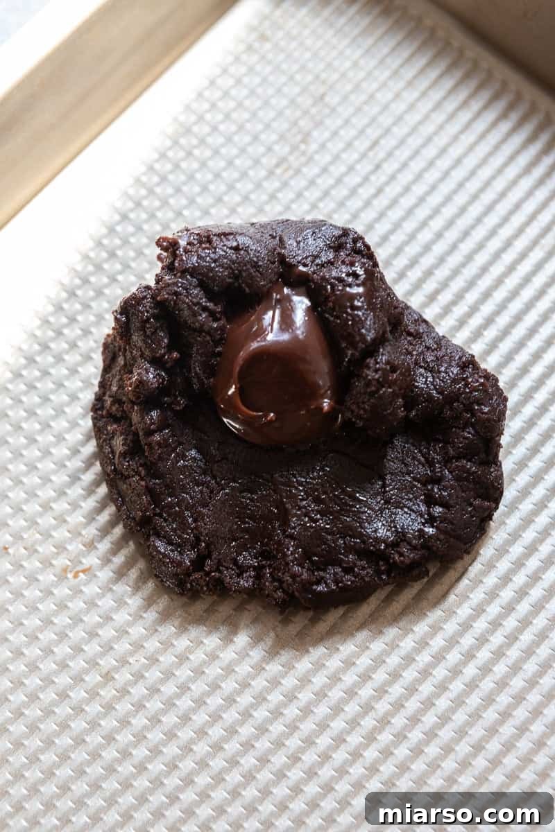 Chocolate cookie dough with a dollop of fudge sauce in the center