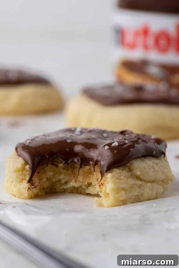 Straight on shot of sugar cookie with Nutella on top