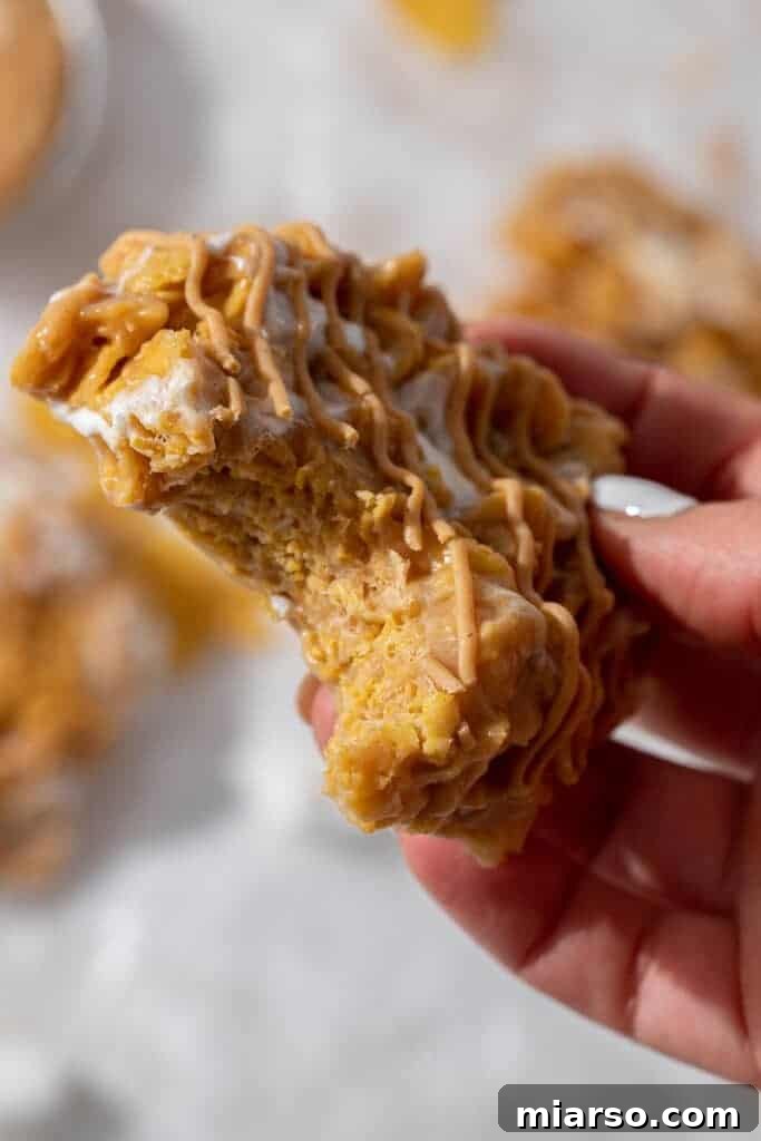 Hand holding cornflakes marshmallow cookies