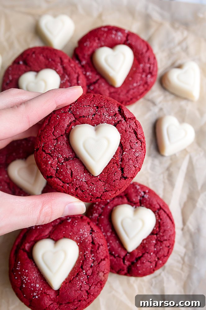 Red velvet sugar cookies with white chocolate hearts on top