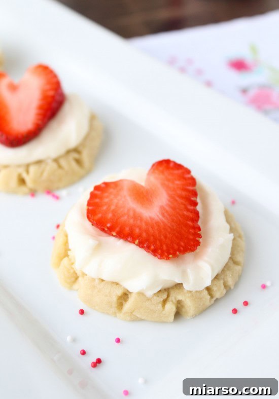 Delightful coconut-frosted sugar cookies adorned with strawberry hearts