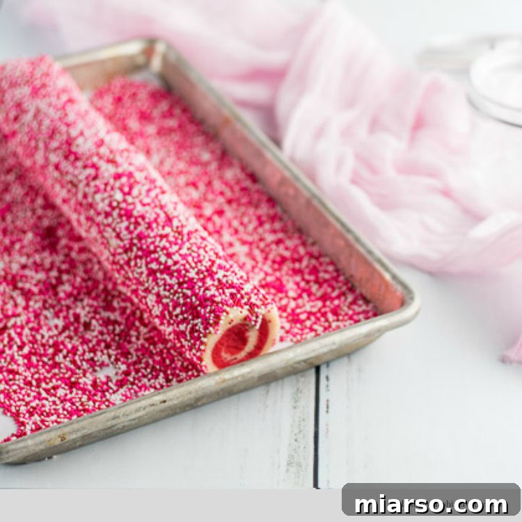 Colorful cookie dough covered in sprinkles for Valentine's Day swirl cookies
