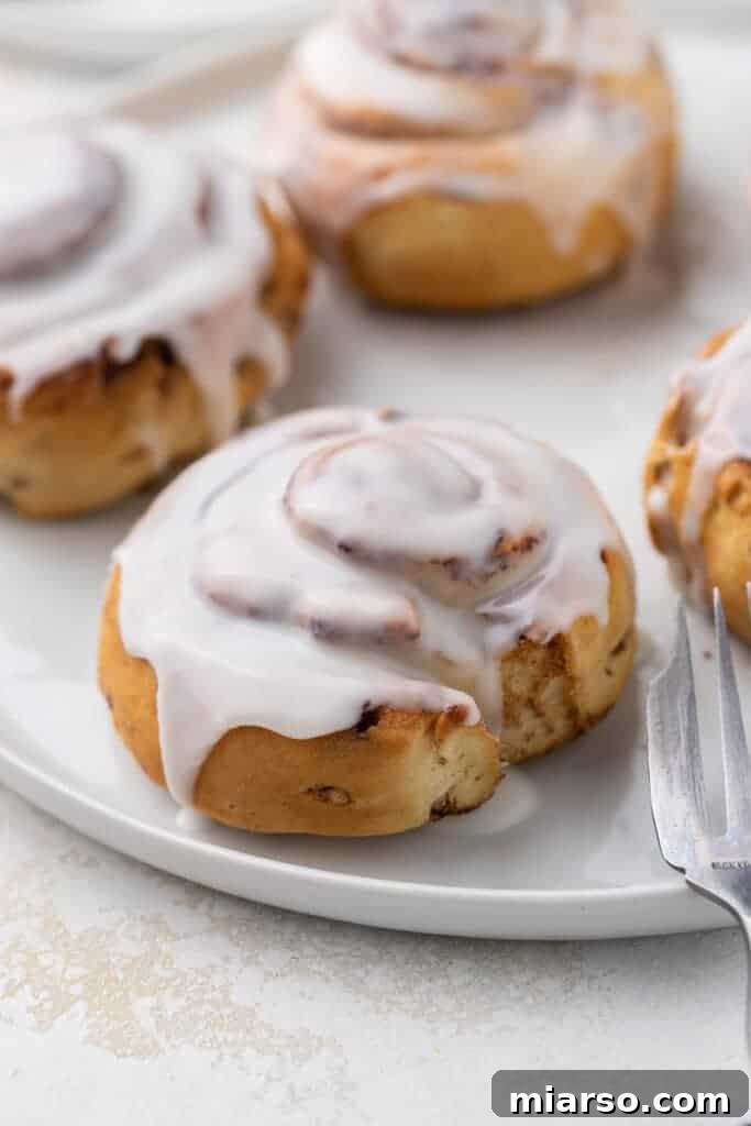 Air fryer Pillsbury cinnamon rolls, golden brown and perfectly baked in the basket.