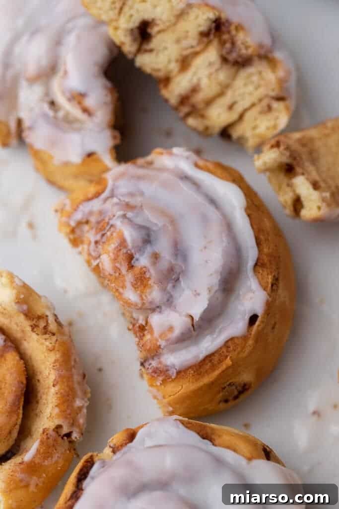A plate of warm, broken-apart cinnamon pastries, invitingly gooey.