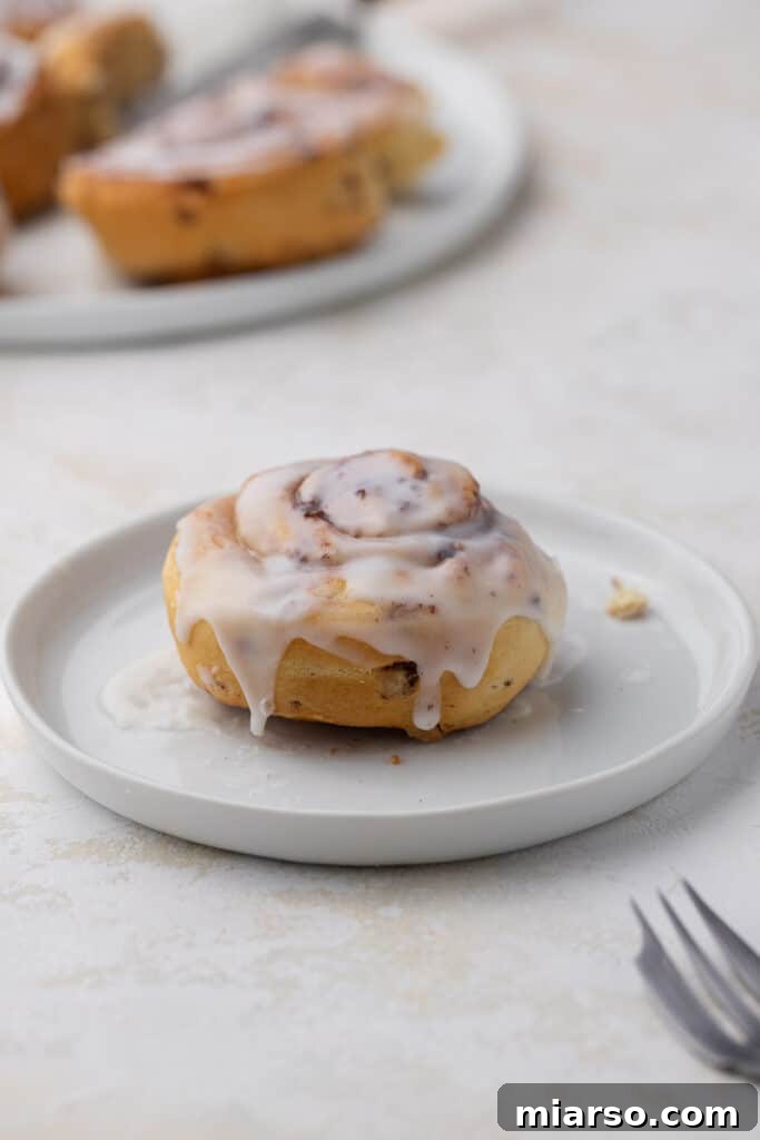 Step-by-step image illustrating how to place cinnamon rolls in an air fryer for cooking.