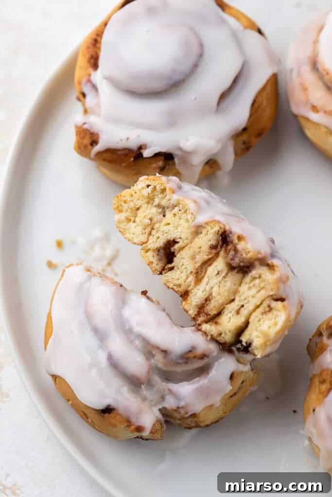 Close-up view of the delicious, gooey interior of a cinnamon pastry.