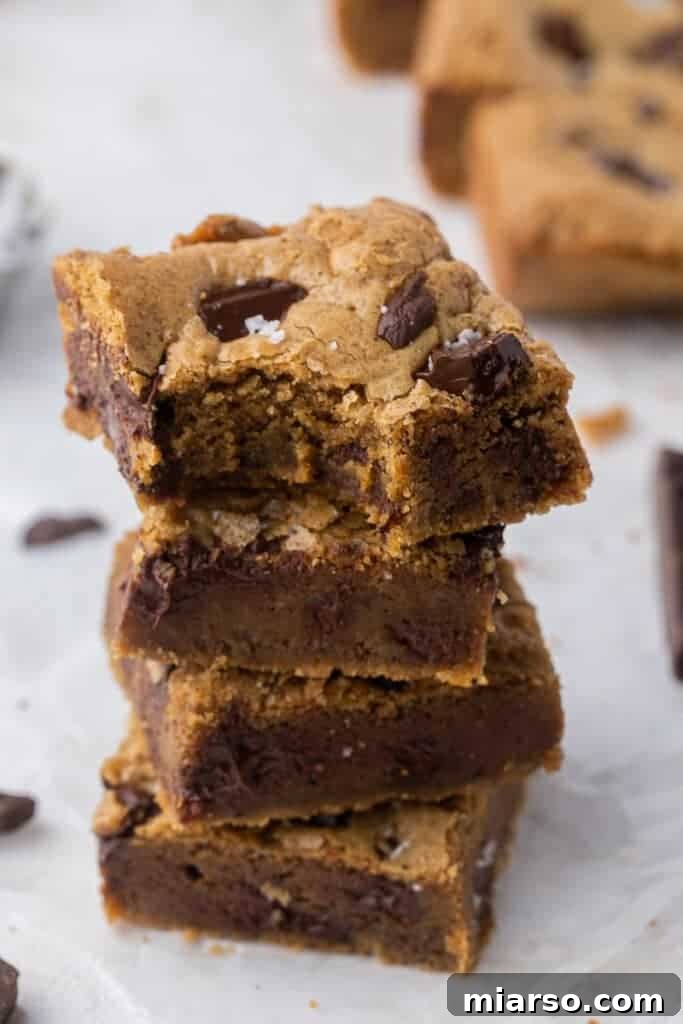 Stack of golden brown butter blondies with chocolate chips