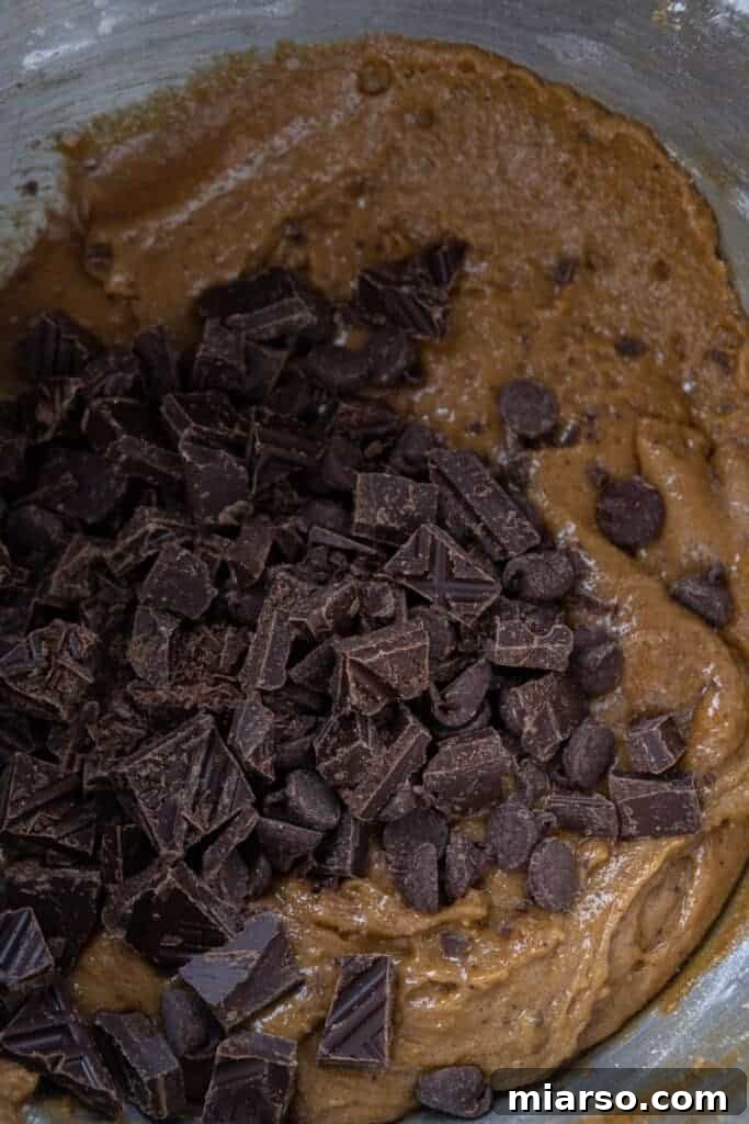 Chocolate chunks being folded into blondie batter