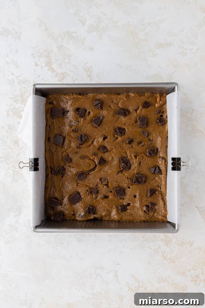 Brown butter blondie batter spread in an 8x8 pan