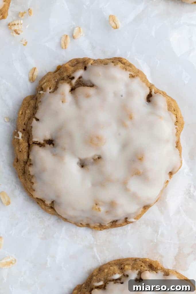 Freshly baked iced oatmeal cookies on a cooling rack, ready to be enjoyed.