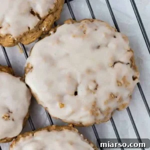 A close-up of a perfectly iced oatmeal cookie, showcasing its textured surface and glaze.