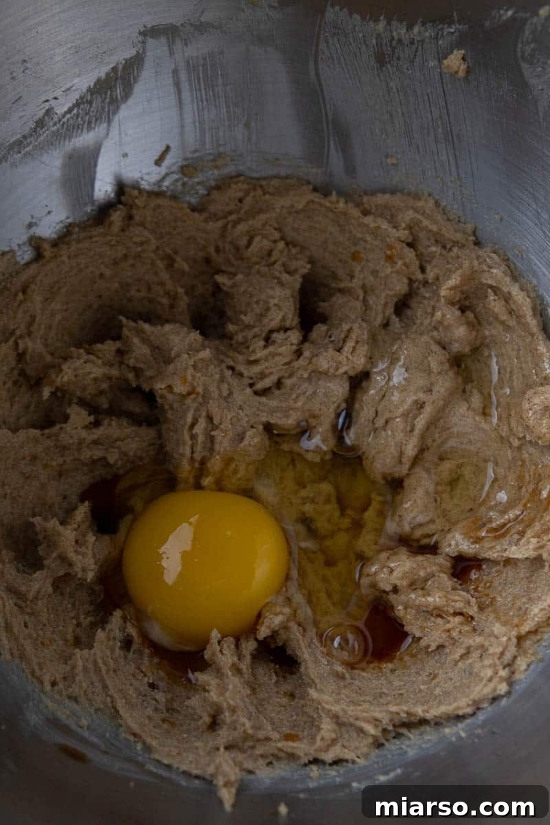 Creamed butter and sugars in a mixing bowl, showing a light and fluffy texture.