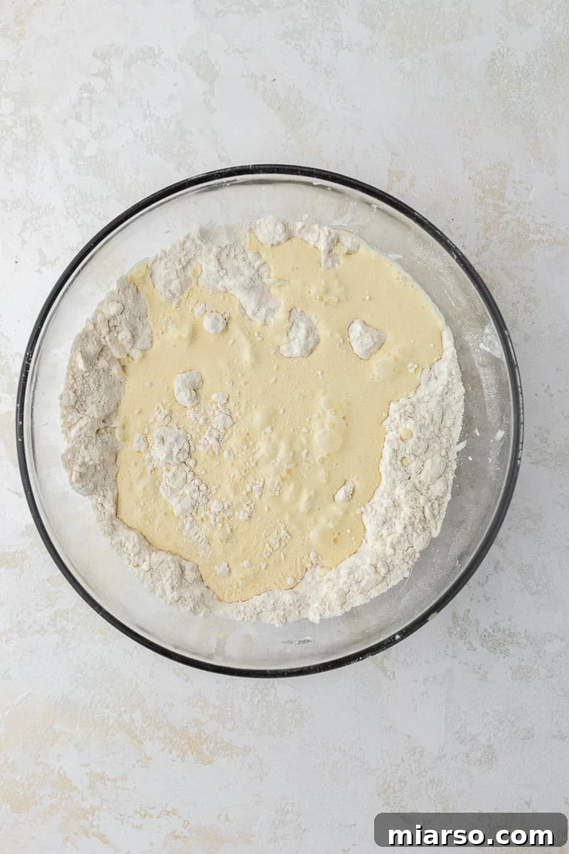 Dry ingredients with heavy cream added in a bowl