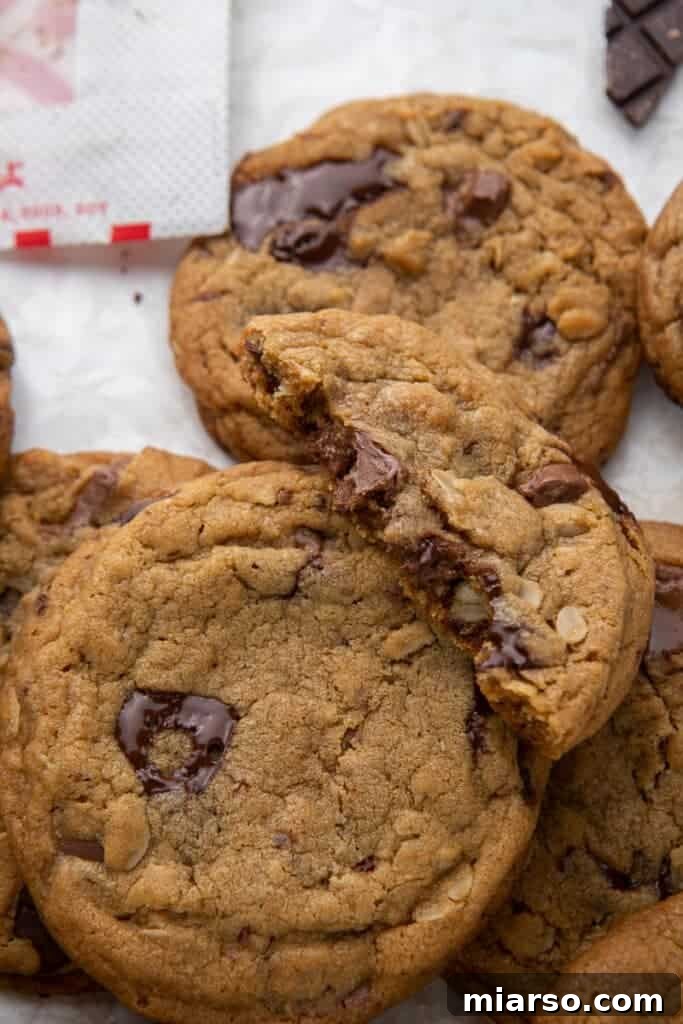 Close-up of a Chick-fil-A cookie cut in half, revealing its soft, chewy interior with melted chocolate chunks and visible oats.