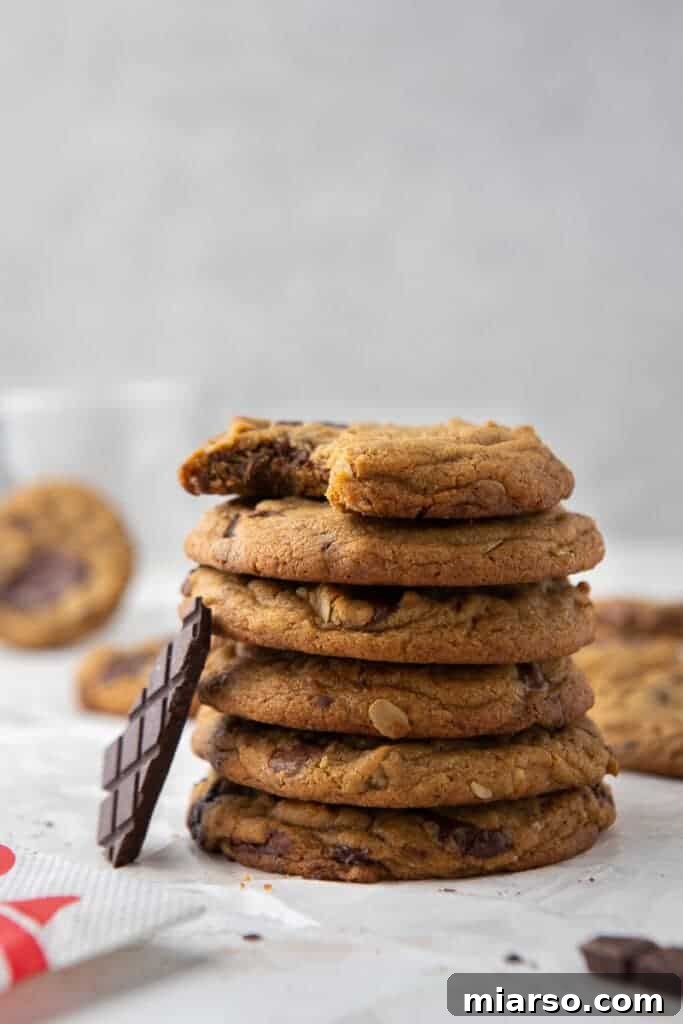 A stack of ingredients for making Chick-fil-A copycat cookies, including flour, sugars, butter, and chocolate chunks.