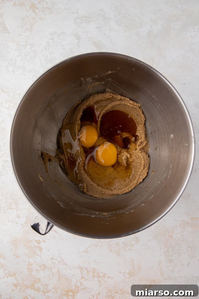 Creamed butter, shortening, and sugars in a mixing bowl, ready for the next steps.