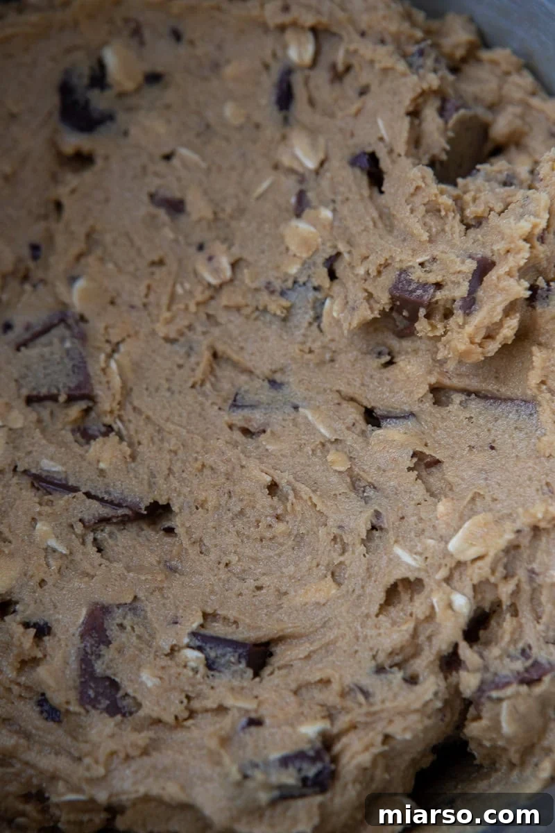 A close-up view of raw Chick-fil-A cookie dough, showcasing the chocolate chunks and oats.