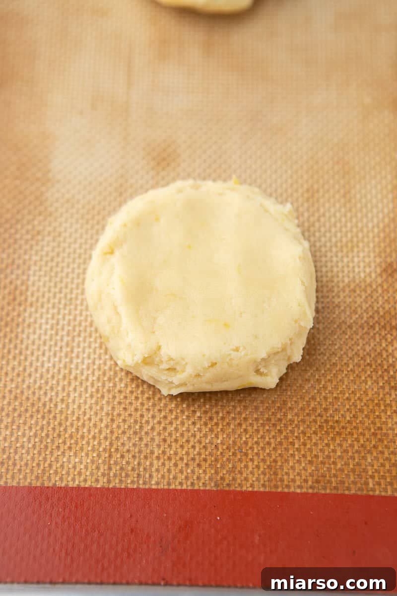 flattened cookie dough on baking sheet 